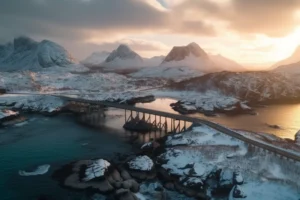 Snow-covered Lofoten mountains and a coastal bridge glowing in soft winter sunset light