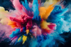 Abstract burst of cyan, magenta, yellow and blue pigment clouds exploding across a dark background.