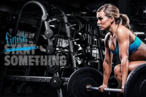Athlete preparing to deadlift a barbell in a dark gym beside motivational text reading finish start something.